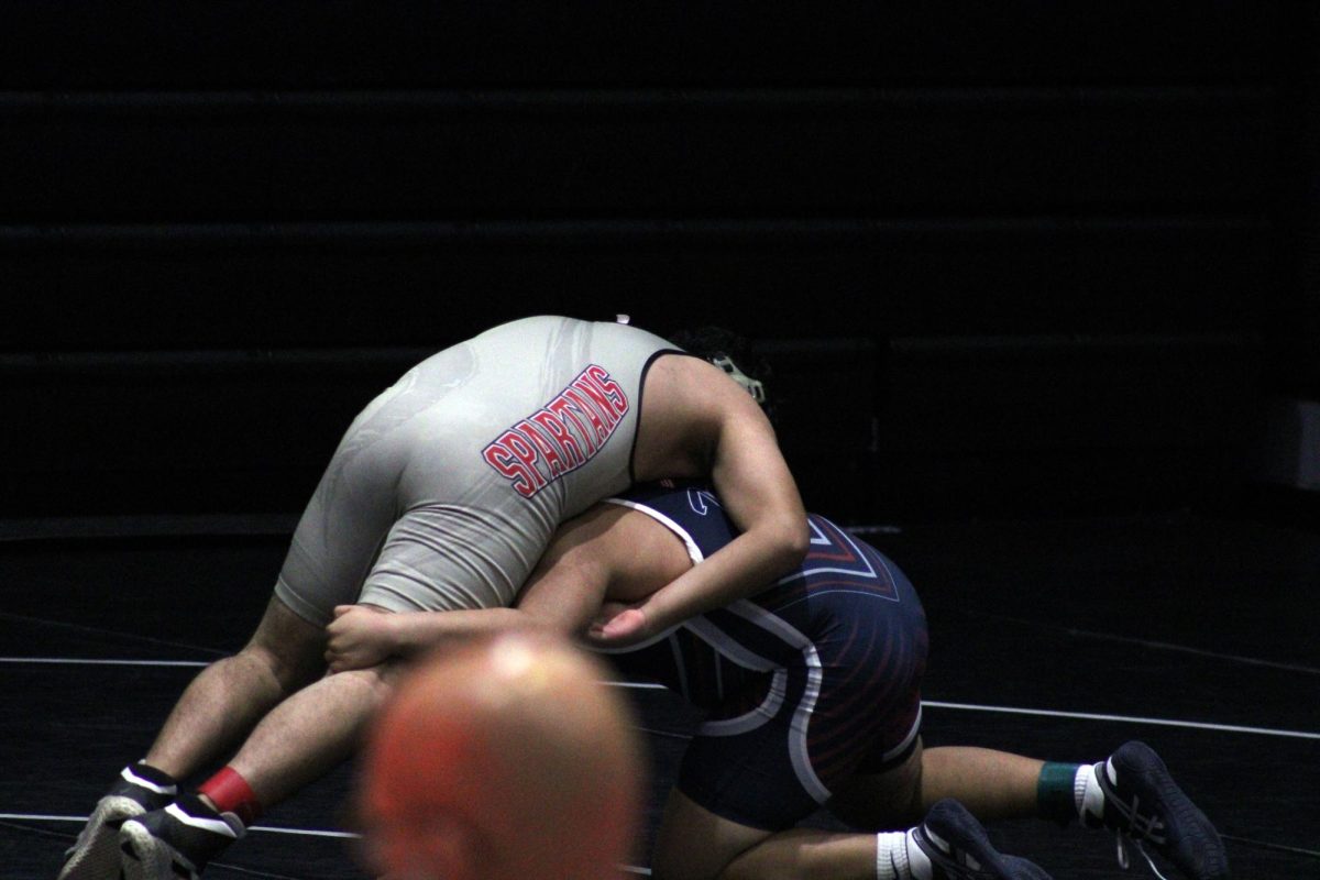 Takedown! Johny _______ taking down an emporea wrestler. Johny won his mach helping Manhattan win the tornement.