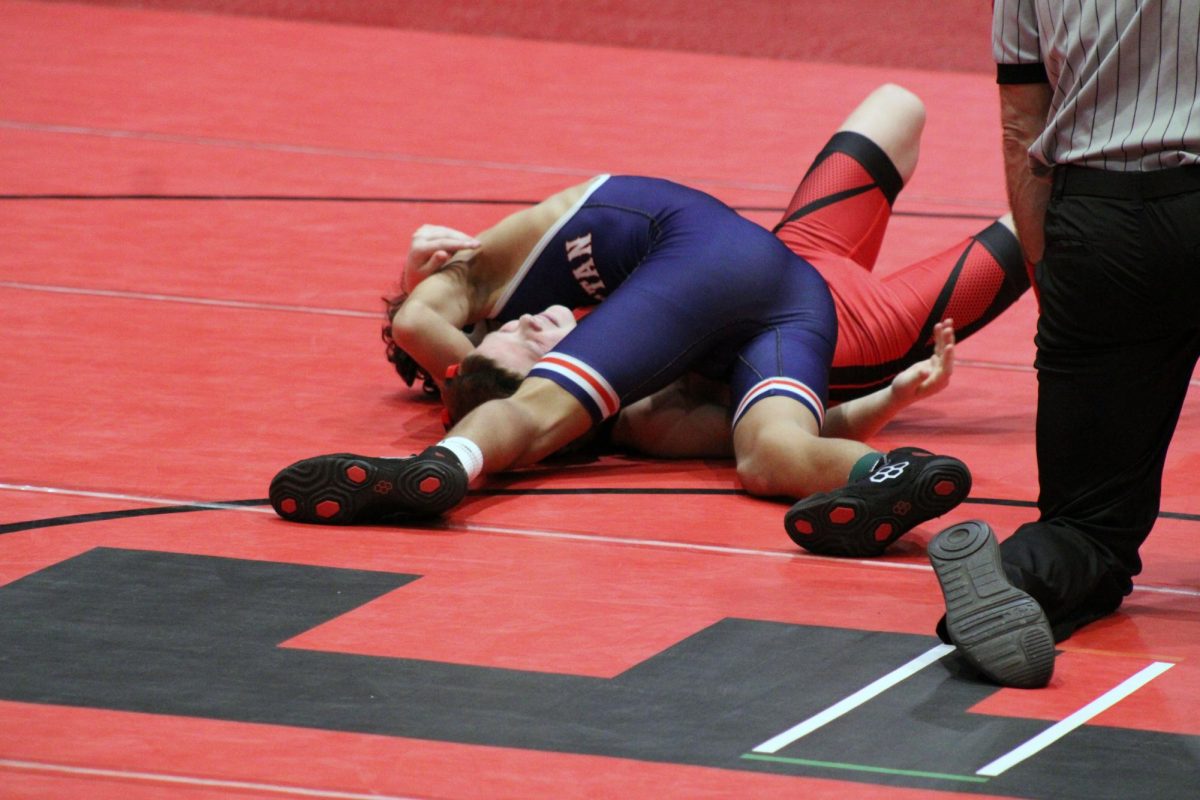 Pin Him! Avery Ahalt in the second round of the tornement pining an Emporia wrestler in the first period earning Manhattan 6 team points. 