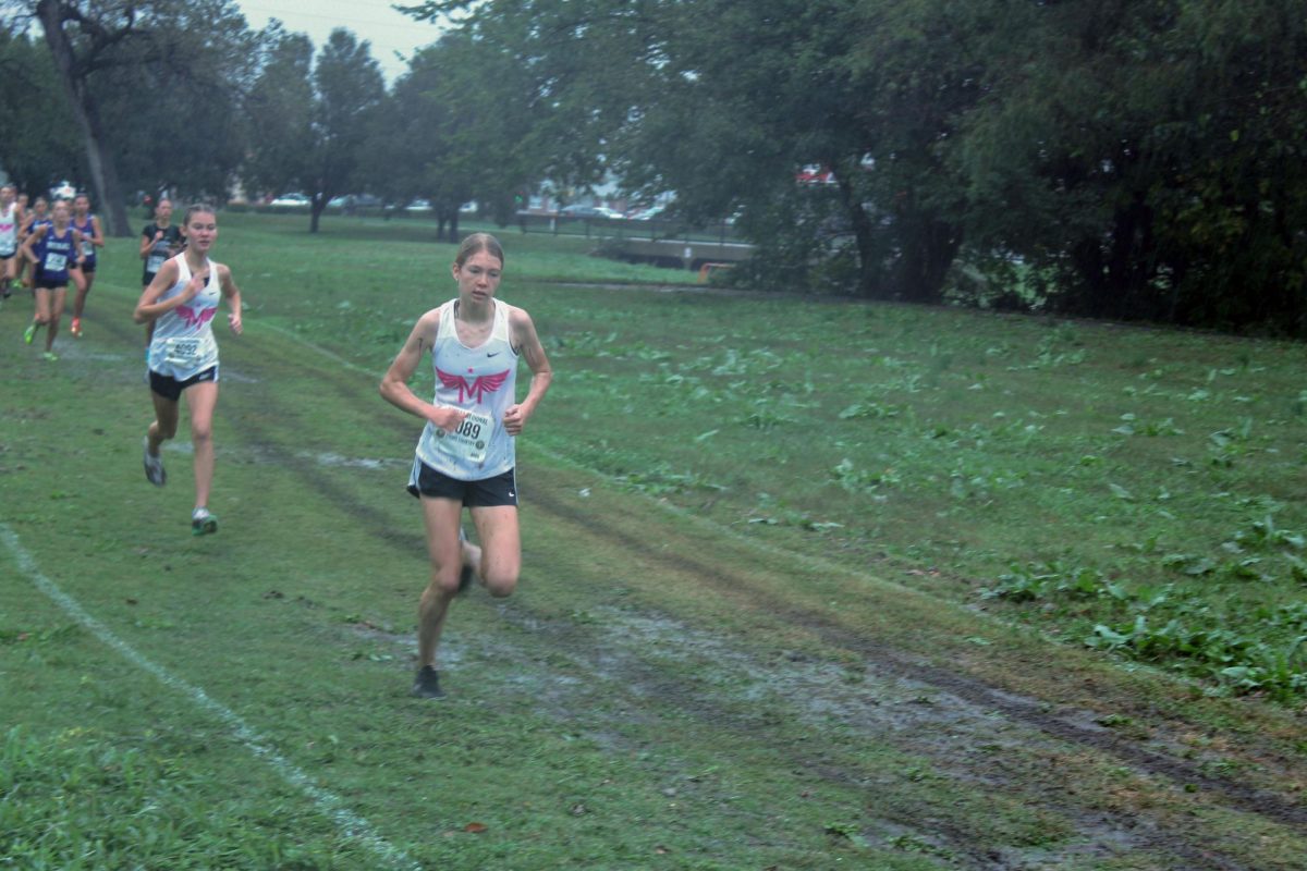 Go Zara! teammates cheer on Zara Koehn as she sprints though the mud. Isla and Zara  placed 2nd and 3rd at Regionals respectfully helping Manhattan to win Regionals. 