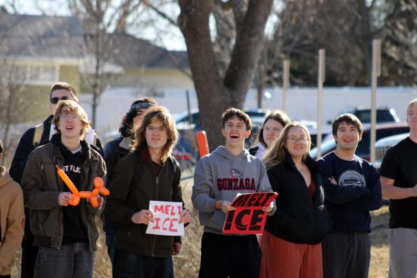 Striving for change Students protest ICE by chanting and holding up signs as cars drive by Poyntz Ave. on Jan. 20. Participants left their final classes of the day early to take part in the protest.