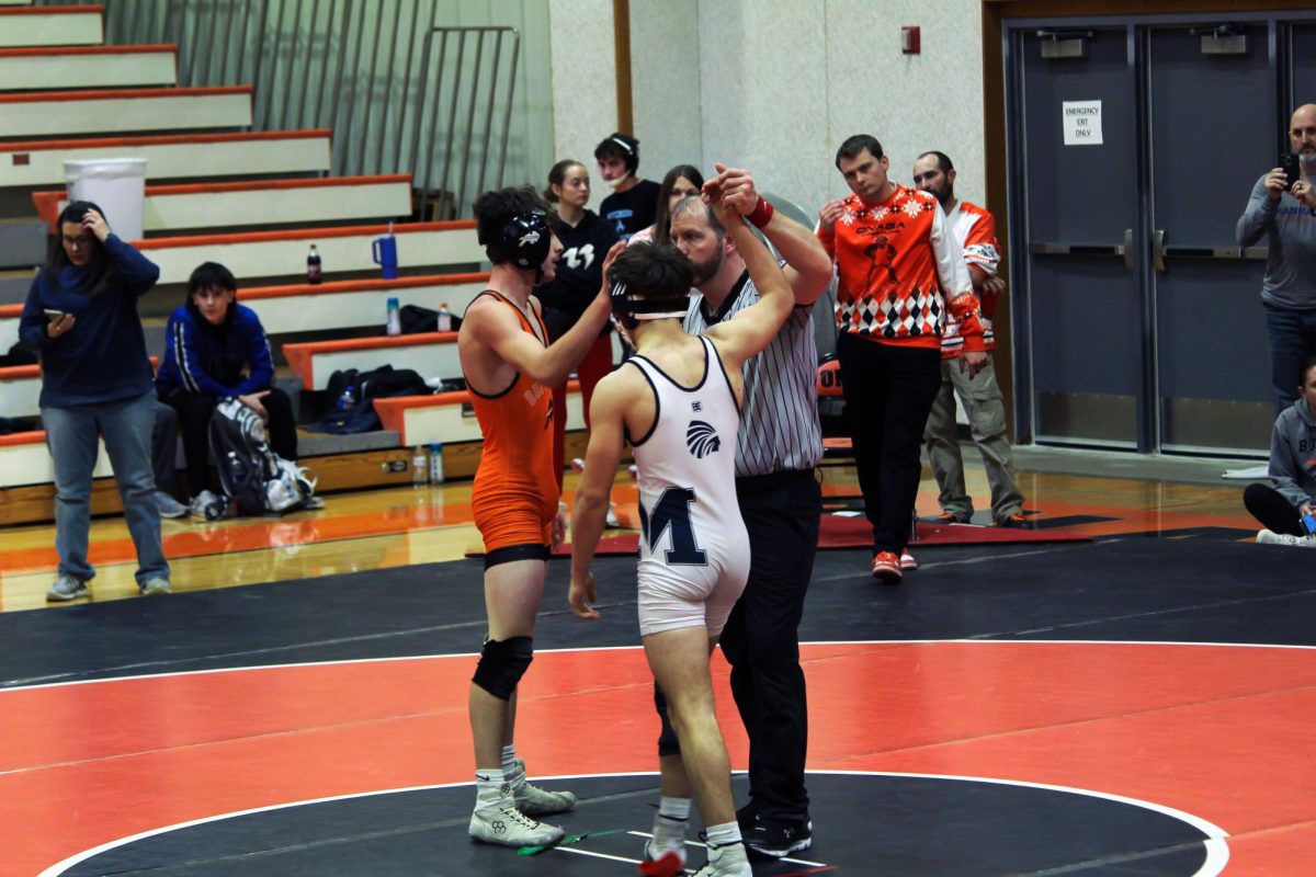Hand raised On Dec 13. Sophomore Ilex Disney clutches the win in the third period and gets raises his hand to signify the win at the Onaga Tournament.
