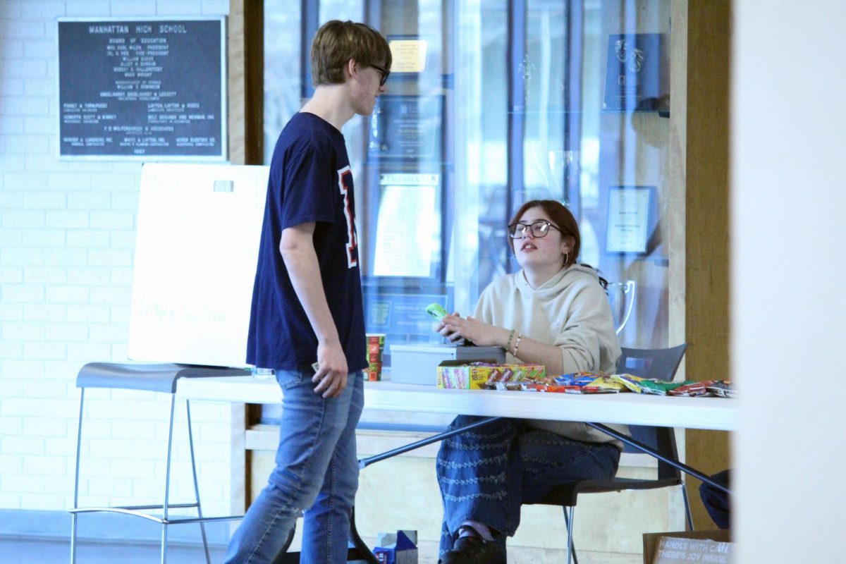 Snack time. During a forensics Tournament, participants and volunteers buy snacks from the MHS students running the table as the event goes on. The contest ran on Feb. 28, where most of the students attending gathered at the tables in the commons as they waited for their time to shine.