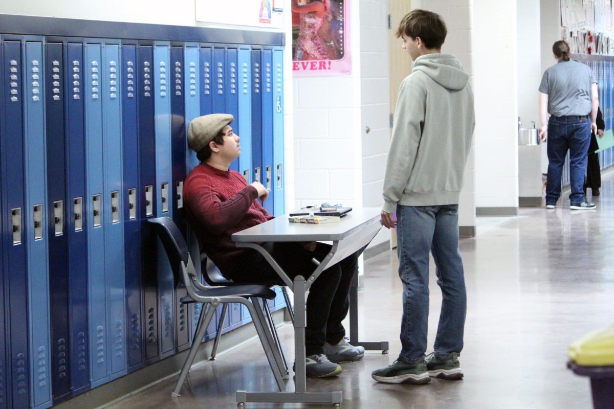 Answering questions. Forensics teacher Will Soper sits in the Tab-room for the Forensics contest that MHS is hosting. Soper’s students helped as well by running the front table, snack bar, and more.  The event was held on Feb. 28.