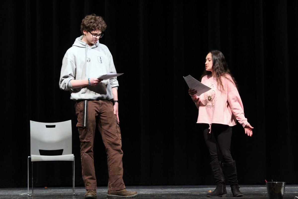 Fighting with words. Junior Micheal King and senior Jaden Wataha act out one of the scenes from the upcoming spring play, Proofs, for the auditions. These two play the characters Catherine and her suspected love interest, Hal, who are bickering about Catherine’s late father’s mathematical proof. Hal wants questions, while Catherine wants him to just go to bed. The auditions were on Mar. 24, and the callbacks were held on Mar. 25, also in Rezac Auditorium.