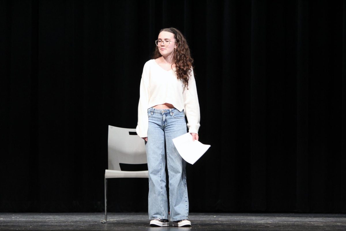 Shining in the spotlight. Junior Alexis Toews acts up a storm as she auditions for one of the female roles for the upcoming spring play, Proofs. The two female characters of this four-character play are Catherine and Claire, the sisters. The other two are the mathematician father and the suspected love interest, Halle. The cast is planned to have two people to a role, this is also called double casting, so then more people will have an opportunity to show off their acting skills.