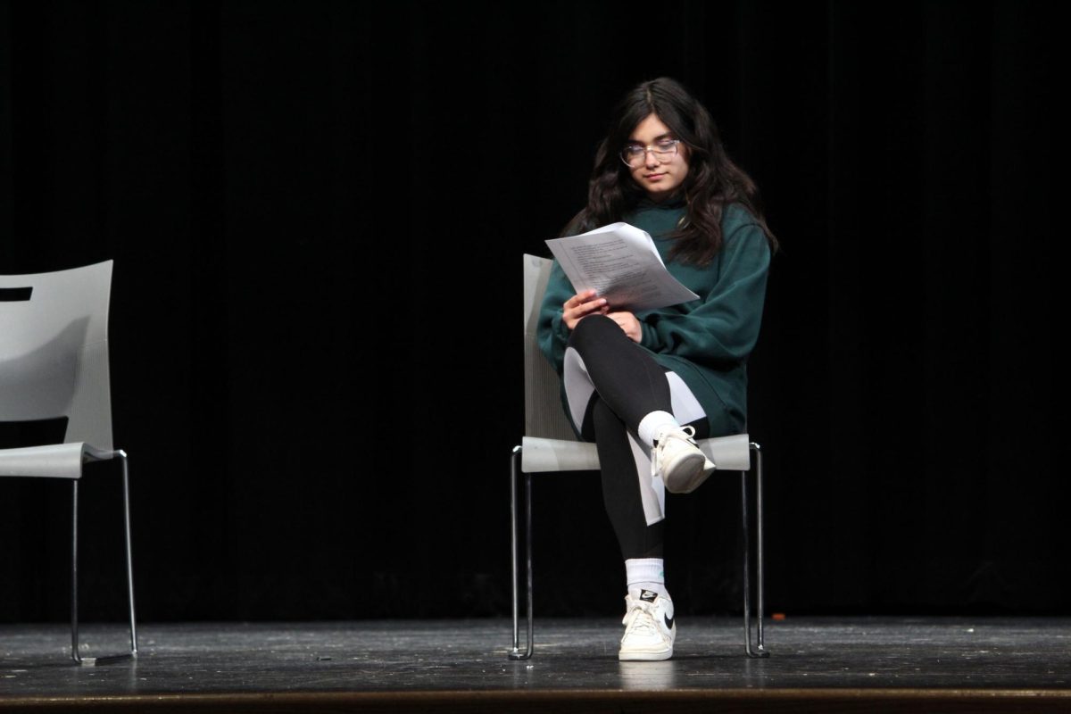 Sitting nice and proper. Freshman Gigi Heckman sits down in one of the chairs offered for a scene she is acting out from the auditions to get a role in the upcoming spring play, Proofs. The scene is not as nice and proper as it looks to be, it is about two characters, Catherine and Hal, bickering over Katherine’s late father’s mathematic proof he conjured up somehow even though he was suffering with dementia. The auditions were held in Rezac auditorium on Mar. 24, after school. The callbacks for the show happened on Mar. 25.
