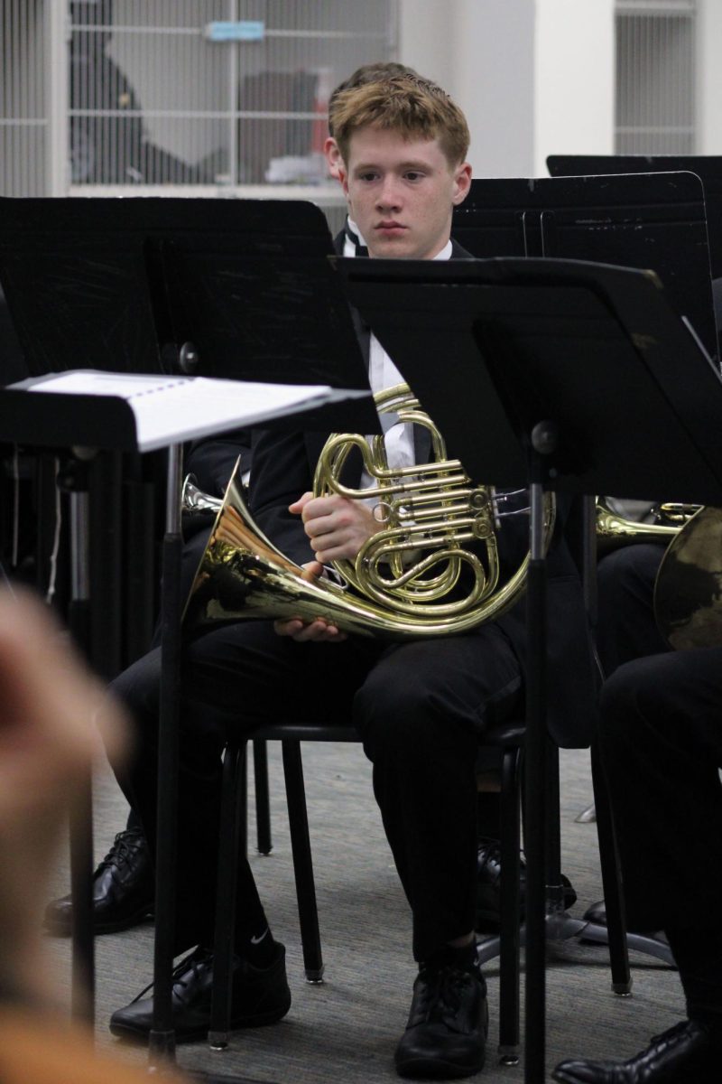 Concert black. Freshman Crosby Crouser prepares himself for his first ever performance at the Regionals Solo & Ensemble contest, which is being hosted at Manhattan High School. The Ensemble Crouser was in was the MHS Brass ensemble, where they played their piece for a judge. That group was the first group to perform in the band room at 8:00 a.m. on Apr. 11.
