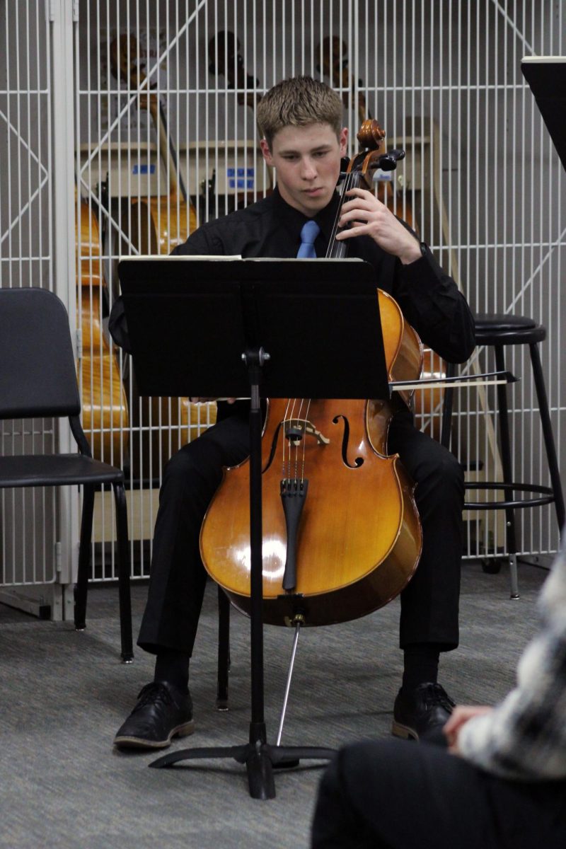 Serious cello. Junior Samuel Byerly rocks out on the cello in all concert black clothes with the group of string players named the C.I.A. or Cellos International Association. Byerly and the three other strings were a quintet group who played a piece by Shostakovich for the Solo & Ensemble Regionals contest, which was on Apr. 11, and was hosted by Manhattan High School.