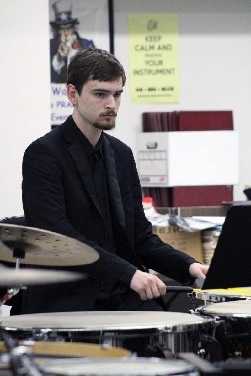 Focused and ready. Senior Ben Pittman hits on the timpani with different sticks and brushes for different sounds. Pittman is performing in the MHS Percussion Quintet for the contest Solo & Ensemble Regionals. The musicians and vocalists are graded by a judge on their playing through divisions. The percussion group got a division 1 as their rating, which is the highest rating you can get. This event was on Apr. 11, at Manhattan High School.