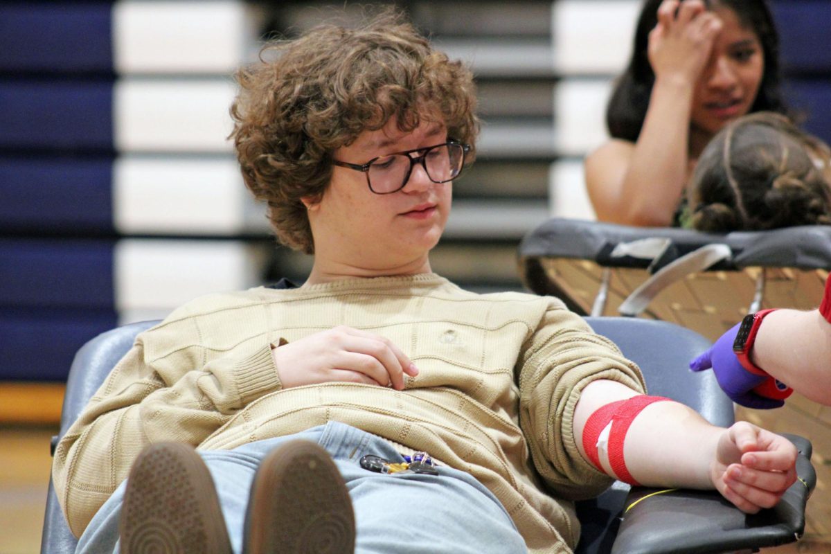 Small acts, big results On Apr. 1, 2026, Manhattan High School’s STUCO invited American Red Cross to the North Gym where students could sign up to donate blood. Junior Bryce Hutchinson is pictured here finishing his donation, joining dozens of fellow students who stepped up to support the community effort. 