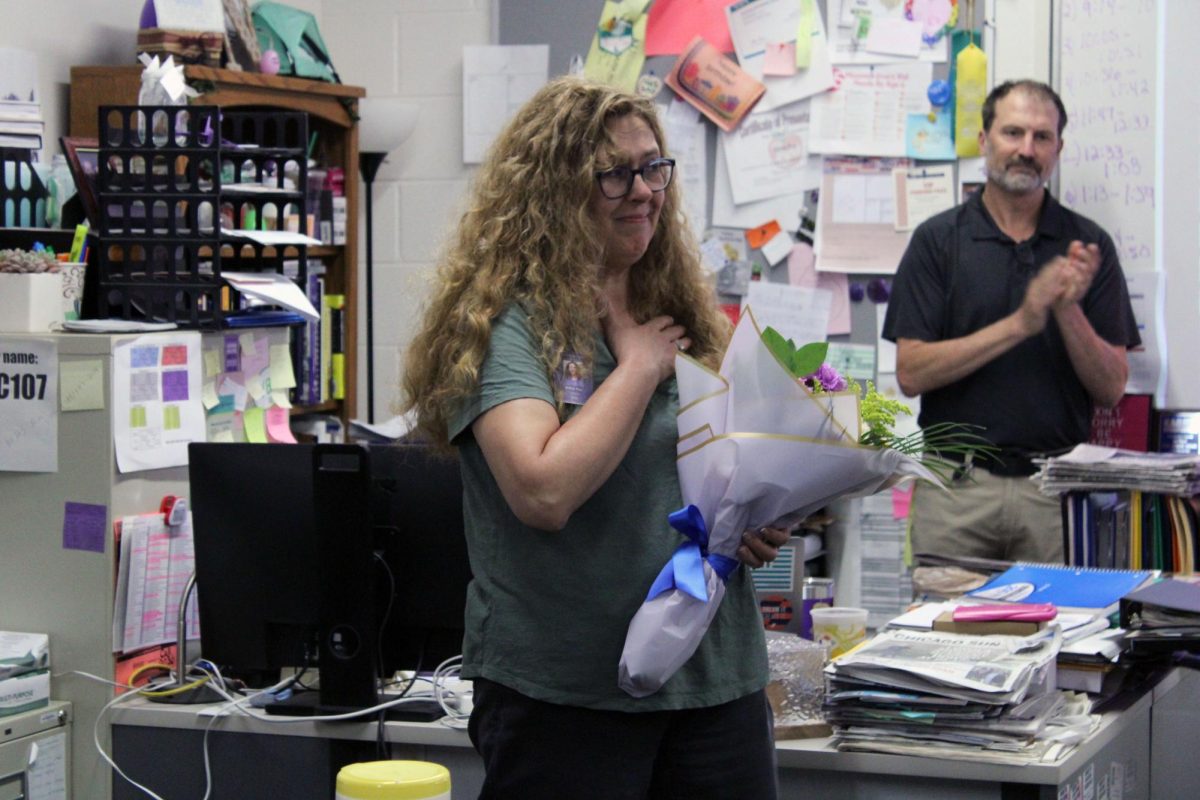 Emotional moments. Media and Publications teacher Kristy Nyp is handed the Jackie Engel Award by Kansas Scholastic Press Association. The Jackie Engel Award is given out to the top Kansas high school teachers who have demonstrated outstanding publication advising skills. The award was given to Nyp as a surprise during the 5th hour class period on Apr. 23.