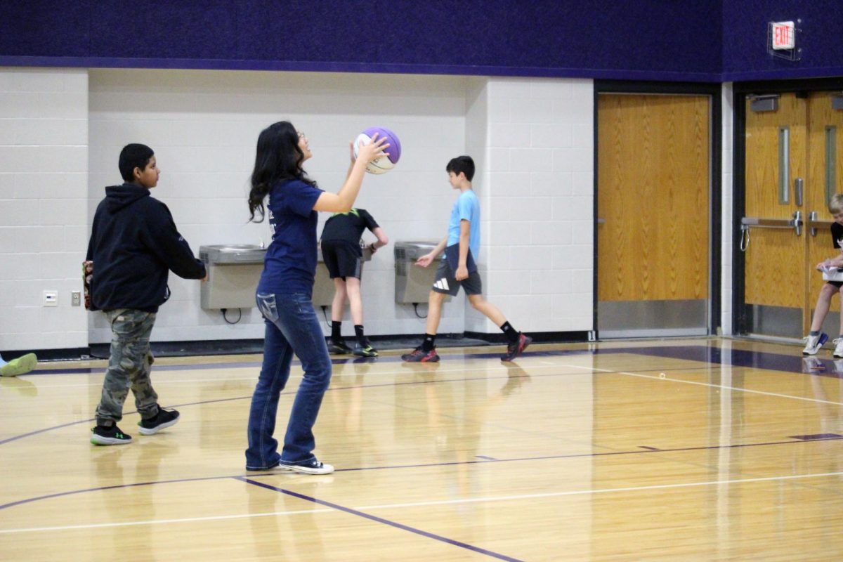 Break time! Freshman Sut Lasham takes a little break in between the Anhtony Middle School passing period to shoot some hoops in the 6th grade gym before the next class is ready. Lasham is a part of the club Students Against Destructive Decisions, or SADD, where she and her fellow members of SADD teach and inform kids about the dangers of substance abuse, alcohol and about bullying. This visit to AMS was on Mar. 31, while another visit to Eisenhower Middle School was on Mar. 30.