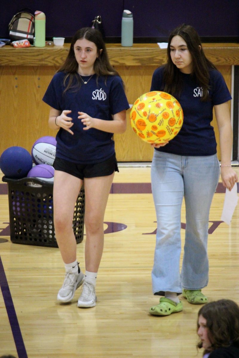 Walk and talk. Freshman Lily Dulaney and freshman Harper Ruder strategies for what they will do with the students for the SADD visit from Manhattan High School to the middle schools in Manhattan, KS. The job for the SADD members is to teach kids about the dangers of propaganda for negative effecting products, making smart and safe choices and to show them to not be a bystander. The visits to the middle schools were on Mar. 30, and Mar. 31. 
