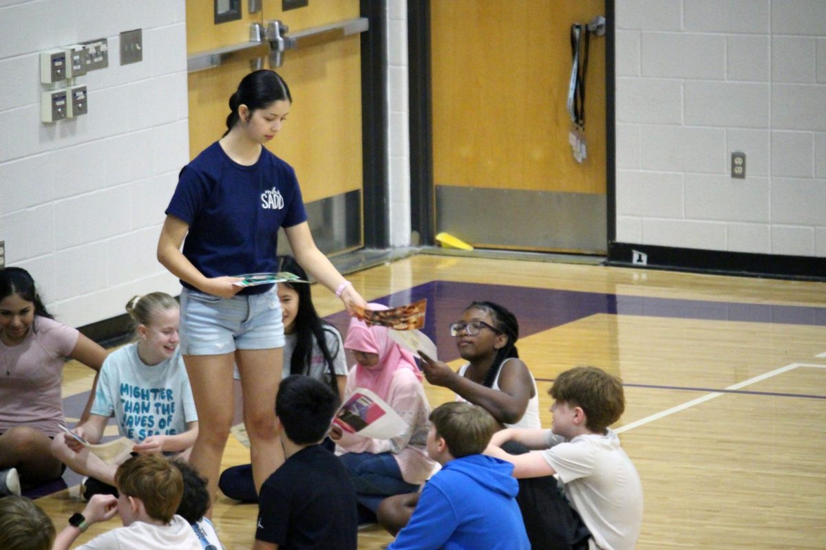 Magazine covers. At Anthony Middle School, freshman Nicole Carranco hands out cut out pages of magazine designs that are promoting one product or criticizing another. Carranco is a part of the Manhattan high School club SADD, which visits schools to teach the young students about making smart and healthy decisions against things like alcohol or nicotine products. SADD visited the middle schools AMS and Eisenhower Middle school as well. AMS was on Mar. 31, while EMS was on Mar. 30.