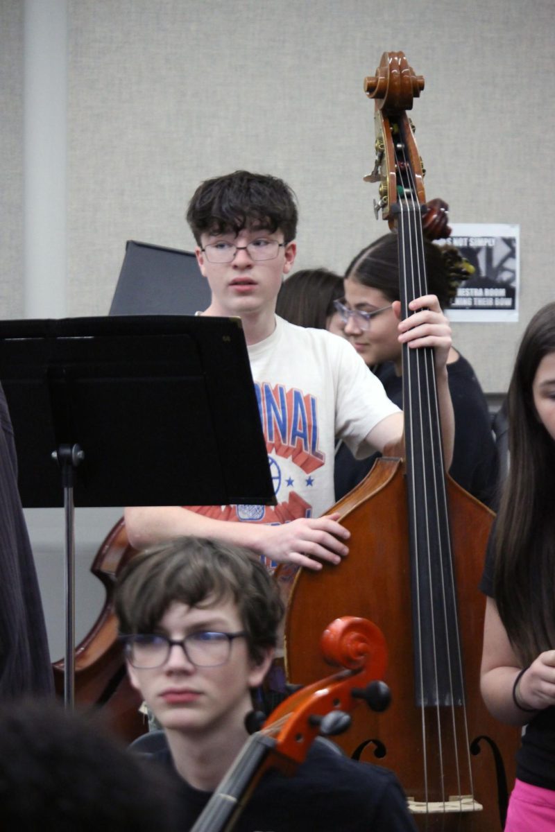 Big bass. Sophomore Johnathan Brown plays his bass with the Anthony Middle School players as the Manhattan high School Symphonic Orchestra plays with their section of instruments in the AMS orchestra that will be going into high school. This event was on Mar. 31 and lasted till around 12:00 P.m.