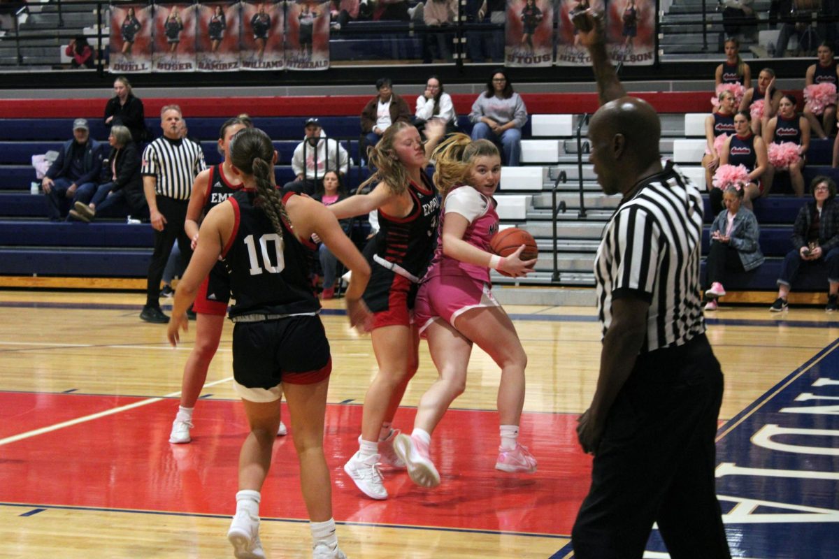 Push off, sophomore Evie Banks pushes off her opponent to look for a shot at the basket. The game on Feb. 6 ended in a 71-31 win for the Indians. 