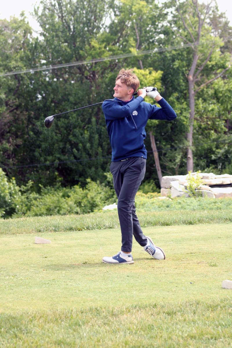 First swing. Senior Will Carpenter swings his club and hits the ball off and away as he begins his turn at the Substate Tournament for the Manhattan High School Varsity Boys Golf Team. The tournament was held on the green grasses of Manhattan Country Club on May 20. 