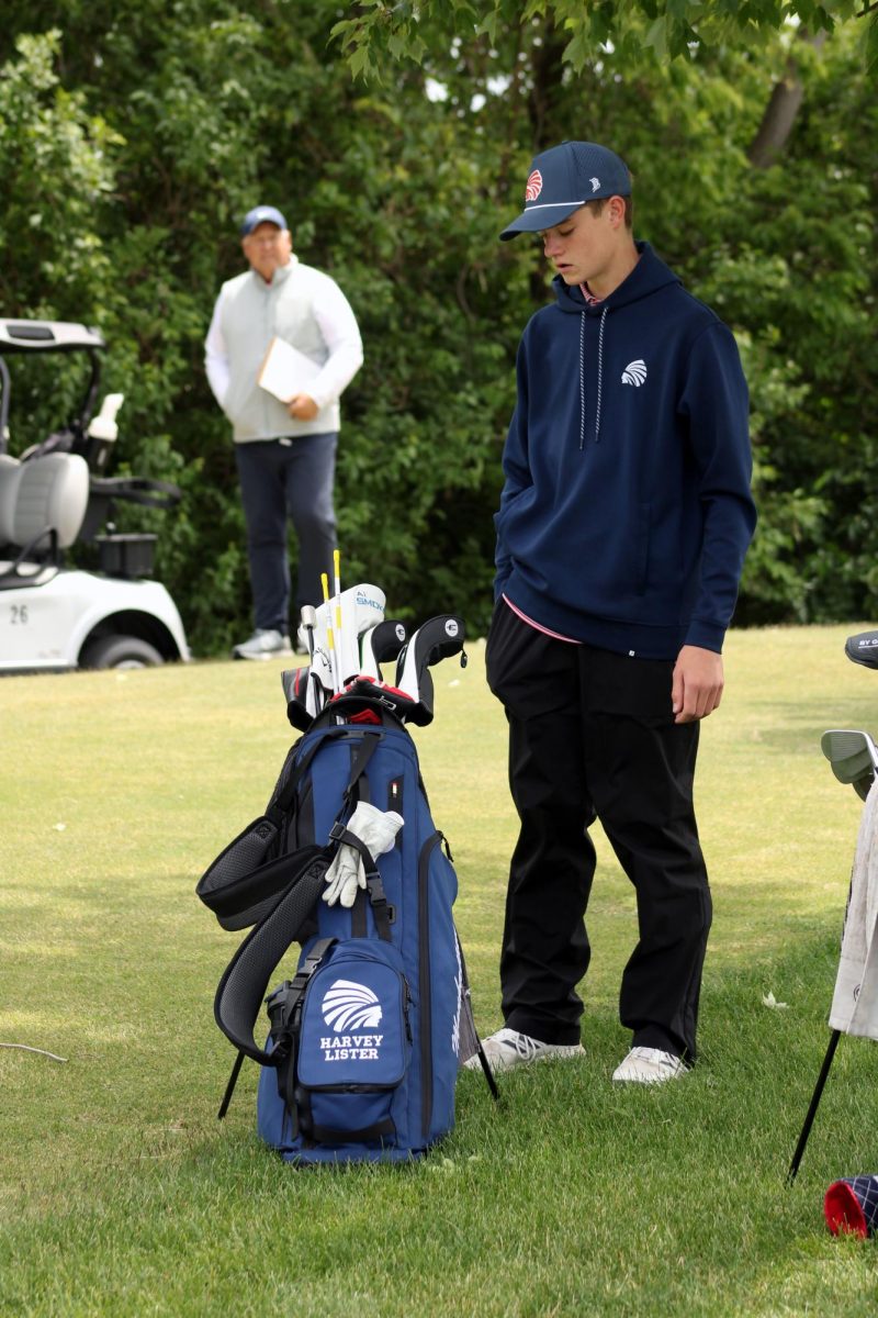 Check and review. Sophomore Charlie Haney got a check in for his points and then begins to figure out what club to use to drive the ball straight into the green. Haney played on the Manhattan Country Club green for the Substate Tournament for MHS as a member for the Manhattan High School Varsity Goys Golf Team on May 20. 