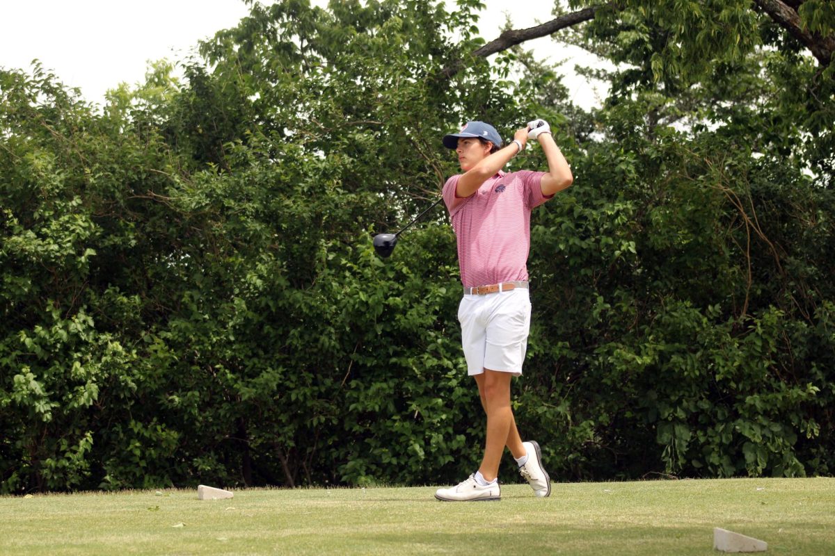 Pink shirt. Senior Cade Cochran hits the ball away and into the next area of green during the Substate tournament that the MHS Varsity Boys Golf Team is playing at. The tournament played out at the Manhattan Country Club on May 20. 
