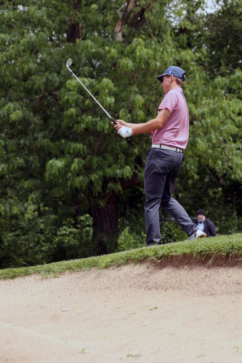 Sand mound. Sophomore Charlie Haney lines up his position with the ball, aiming to putt the ball right into the hole for the MHS Varsity Boys Golf Team during the Substate tournament. The tournament took place at Manhattan Country Club on May 20, where these high schoolers play against other schools and hope to win a spot at State. 