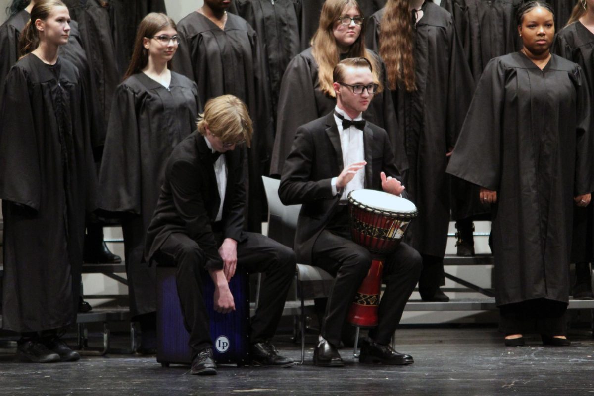 Drums. Senior Dezi Massengale and senior Kimball Morris play out the rhythmic beats of the piece of music that the treble choir sings along with. These two musicians who also sing in the choir, perform with the treble choir during the final choir concert on May 13.