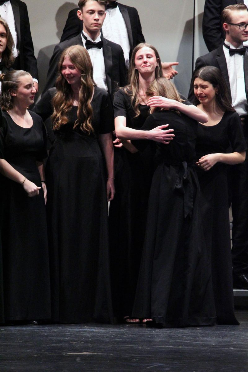 Hugs. The seniors of the Manhattan High School Choirs cry happy and sad tears as they hold and embrace each other on their final concert on May 13. The final concert for all choirs always has gifts given from the seniors to the MHS Choir Director, Chad Pape. 