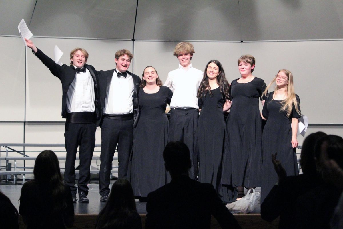 Three cheers for choir! The Pops Choir seniors bow for the crowd as they finish a surprise arrangement of the song “Rainbow Connection,” a beloved song in the house of the choir director Chad Pape. This was on May 13, during the final MHS Choir Concert as a surprise from Pape’s son, senior Micah Pape (middle). 