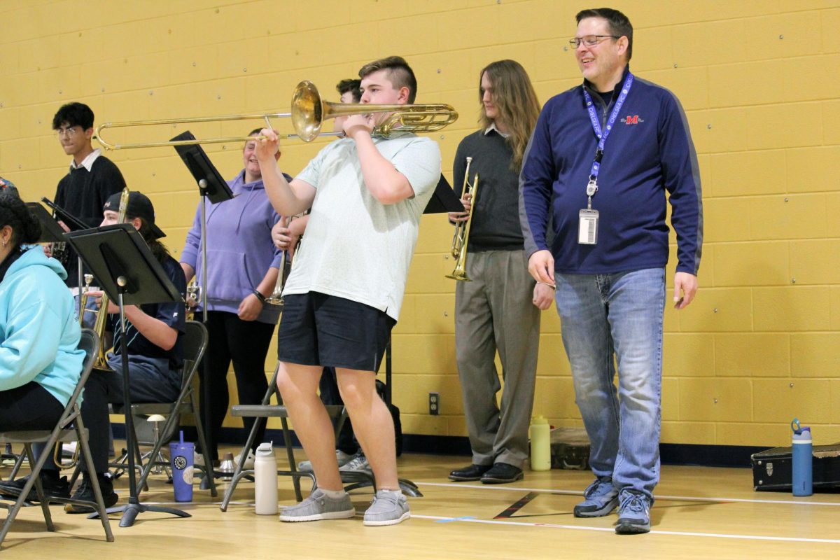 Big blat. Freshman Bob Maxwell gets the approving grin from jazz band teacher Devin Burr, as he rocks out his low and loud solo on the bass trombone. The MHS Blue Notes jazz band visited two elementary schools, Ogden and Woodrow Wilson on May 1. From the seating for next school year’s jazz band lineup, Maxwell, the soon-to-be sophomore, will be the section leader of the whole trombone section while still honking on the bass trombone.