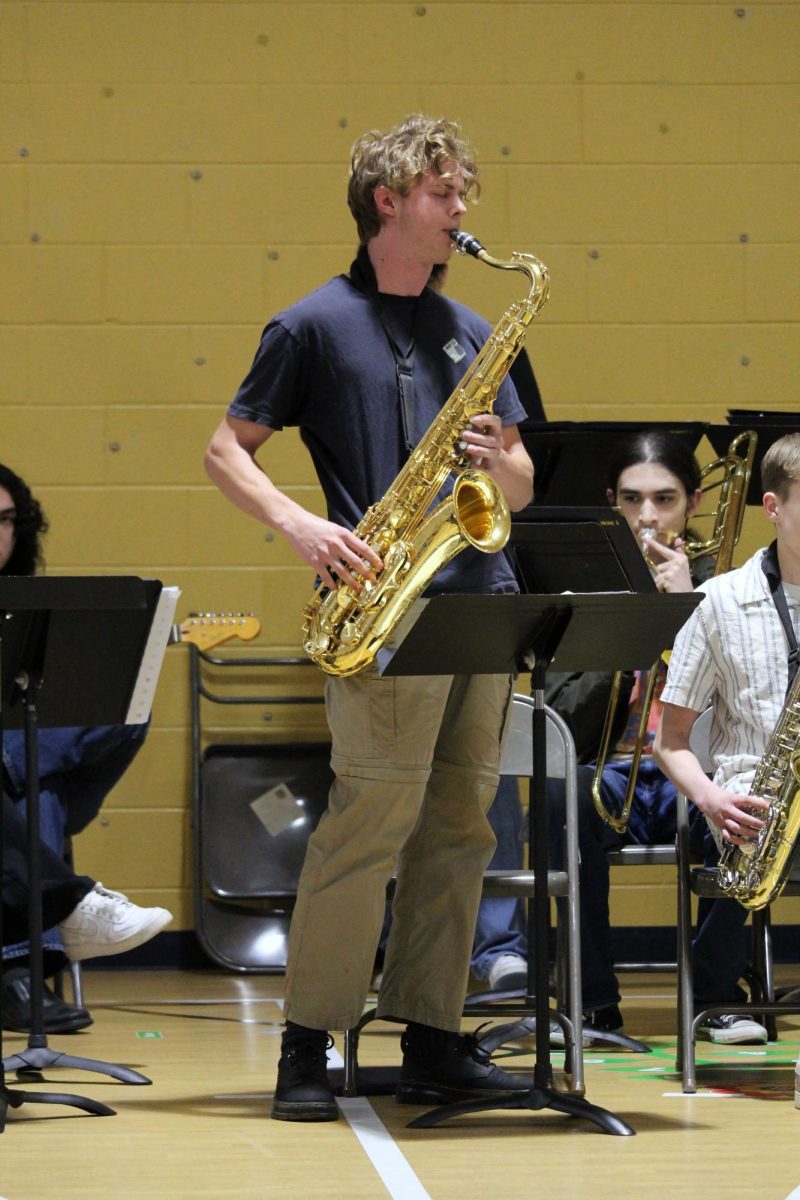 Taking in the moment. Senior Ian Hupp plays out on his solo during one of the many songs that the MHS Blue Notes jazz band plays for the elementary schoolers. The jazz band played in front of many kids at Ogden Elementary and Woodrow Wilson Elementary on May 1.
