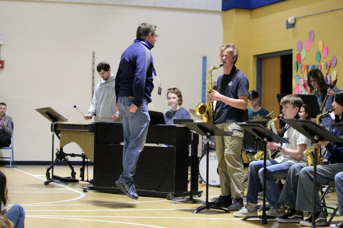 Hop! Manhattan High School Jazz Band teacher Devin Burr takes a big jump to cut off the band. The Blue Notes Jazz Band played for Odgen Elementary and Woodrow Wilson Elementary on May 1, to show them the wonderful world of jazz and jazz band.
