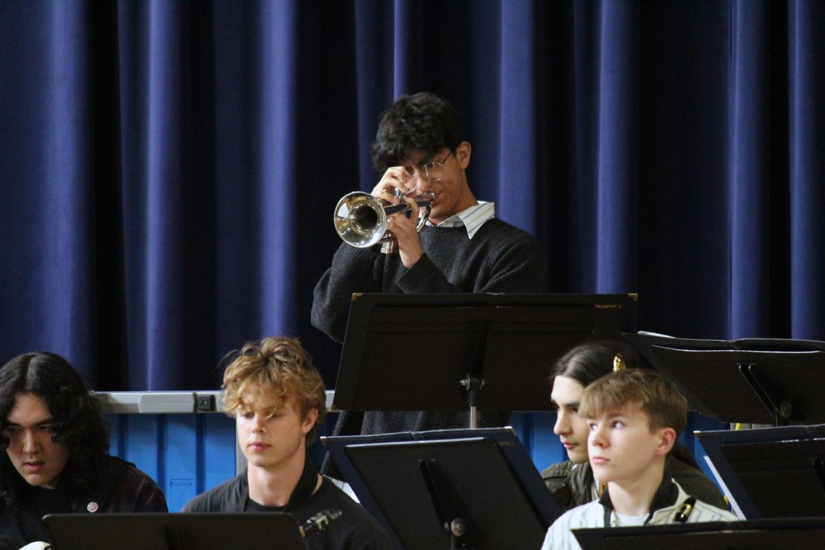 Solo. Senior Favian Gomez plays high and mighty while improvising a solo in one of the many songs being played by the Manhattan High School Blue Notes Jazz Band for two elementary schools. The students in the band got to leave school early on May 1, and visited two schools, Ogden Elementary and Woodrow Wilson Elementary.