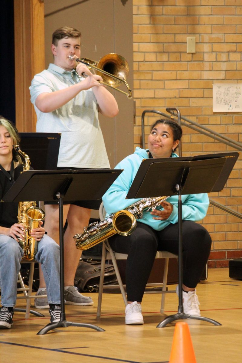 Watch out! Junior Khamania Robinson looks up above to beware the loud and proud bass trombone player, freshman Bob Maxwell. They are a part of the MHS Blue Notes Jazz Band, where on May 1, they left school early to visit two elementary schools, Odgen and Woodrow Wilson. For most soloists, they are told to stand up when they’re playing their solo. Most can do this memorized, or their solo is purely improvised.